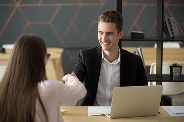Smiling hr manager handshaking successful applicant hiring or greeting, friendly satisfied employer offering job contract shaking hand of winning candidate at interview, employment recruiting concept